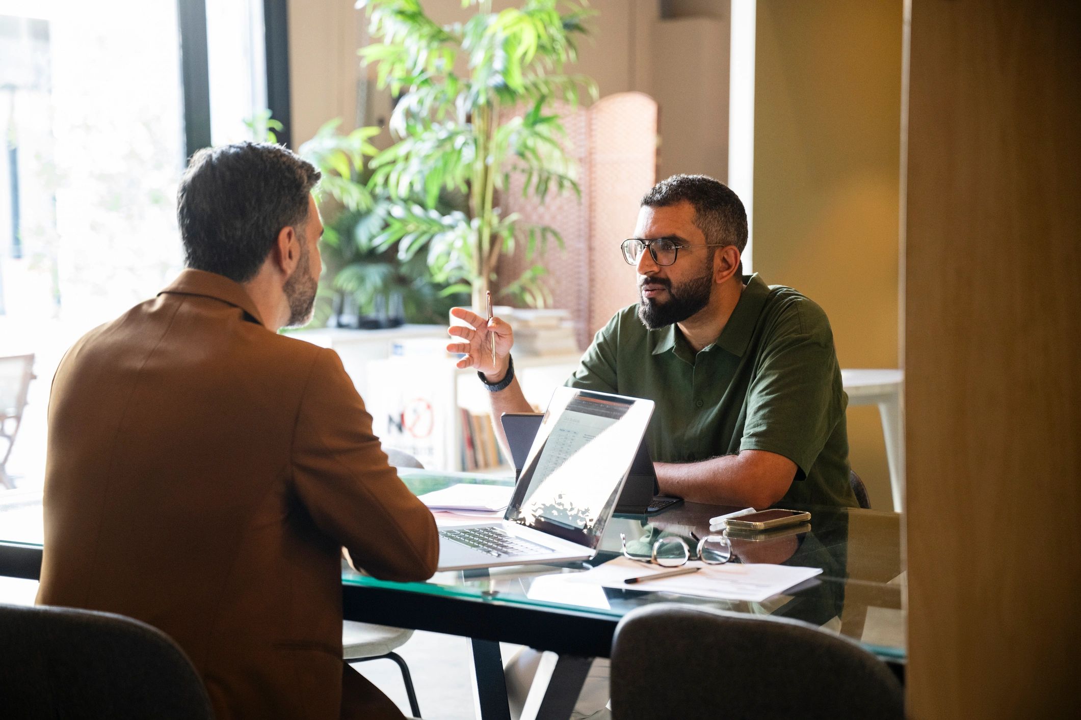 Financial advisor meeting with a client in a modern office