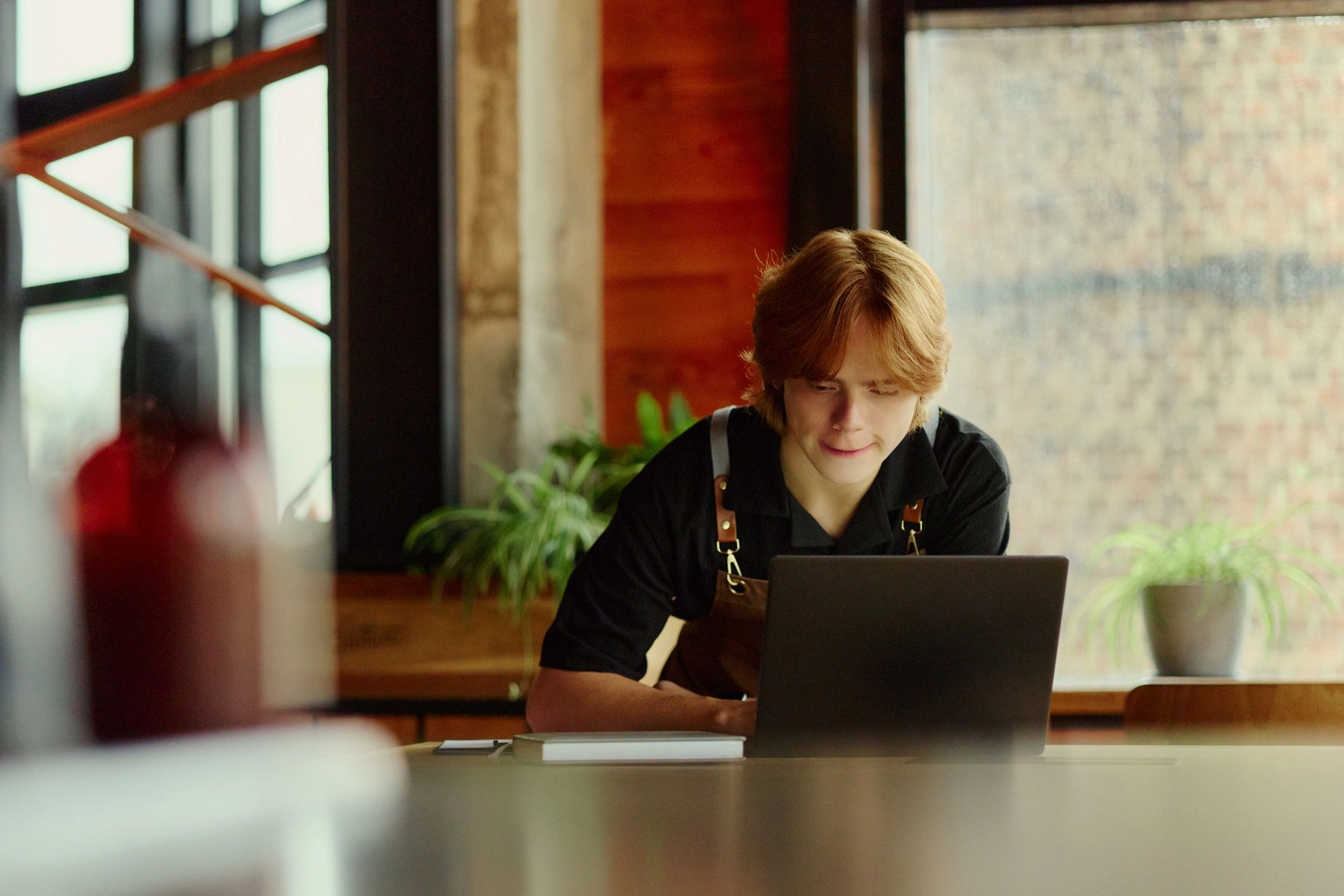 Small business owner managing records on a laptop